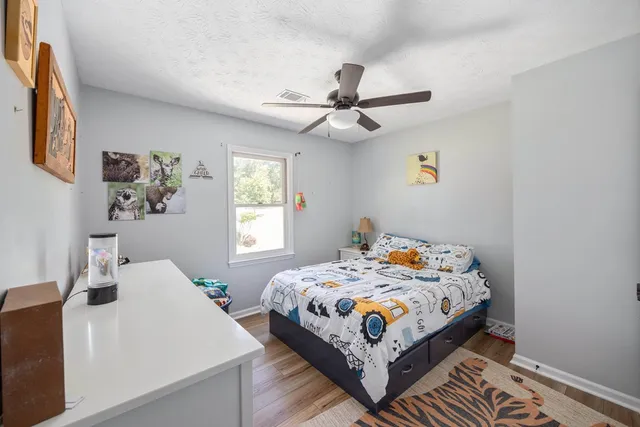 a bedroom that has a bed and a chandelier