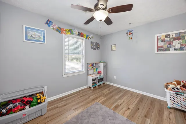 a room with painting on the wall and a window