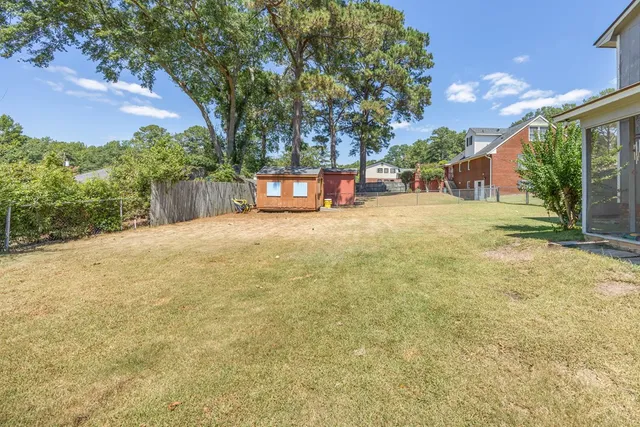 a backyard of a house with table and chairs
