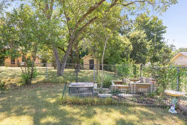 a backyard of a house with yard swimming pool and outdoor seating