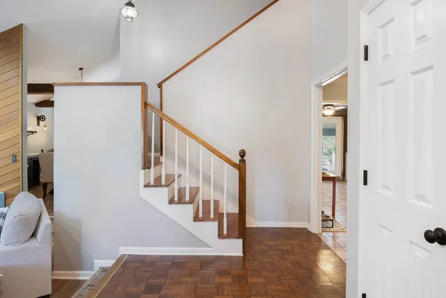 a view of a hallway with wooden floor and entryway