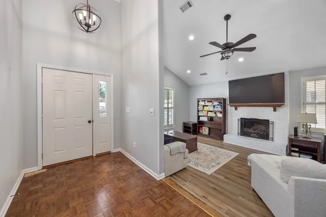 a living room with furniture a fireplace and a flat screen tv