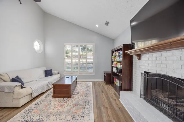 a living room with furniture and a fireplace