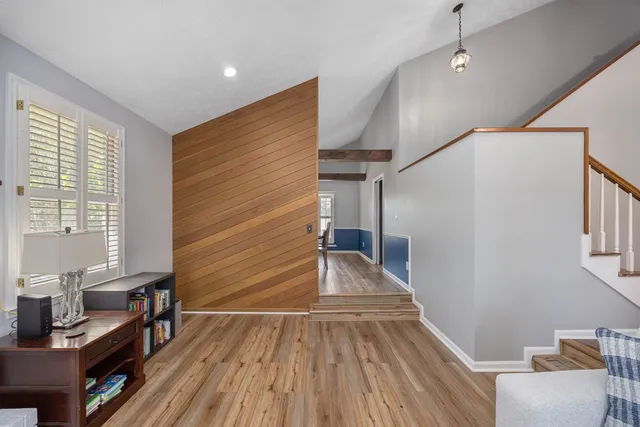 a view of entryway with wooden floor and dining room