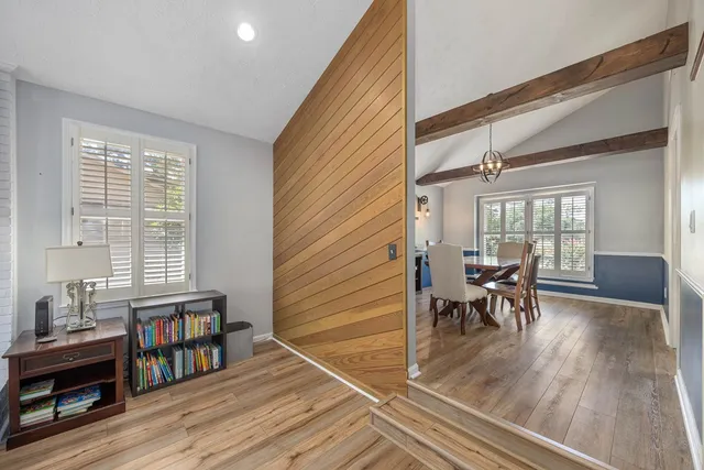 a dining room with furniture and wooden floor