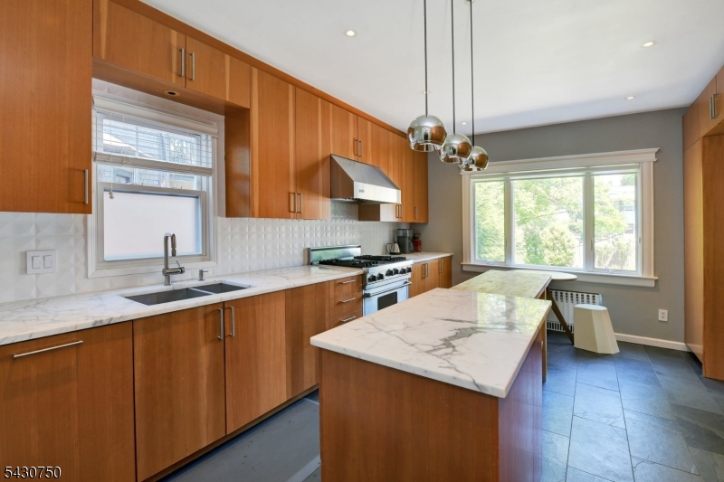 42 Norman Road Montclair, NJ 07043 - Photo 14 of 33 a kitchen with a sink a counter top space and cabinets