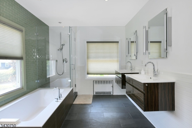 42 Norman Road Montclair, NJ 07043 - Photo 19 of 33 a bathroom with a tub sink and mirror