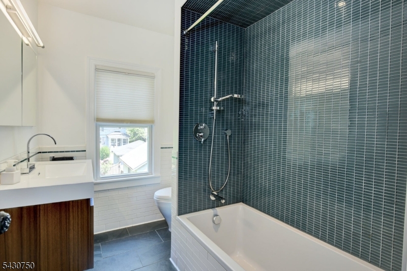 42 Norman Road Montclair, NJ 07043 - Photo 24 of 33 a bathroom with a bathtub sink shower and window