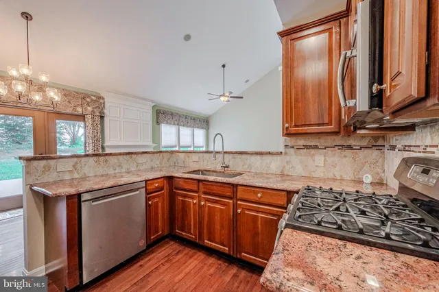 a kitchen with stainless steel appliances granite countertop a stove and a refrigerator