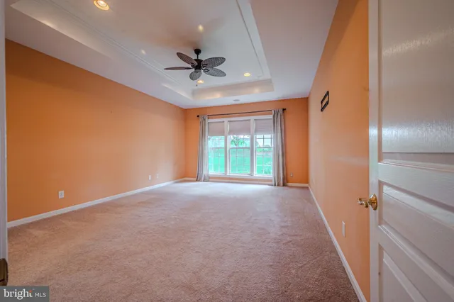 a view of a livingroom with a ceiling fan and window