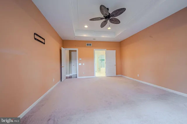 a bathroom with a granite countertop double vanity sink a mirror a bathtub and shower