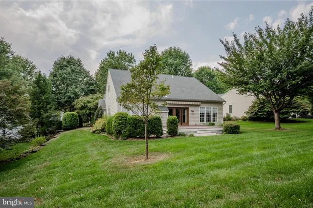 a view of field with grass and trees in the background