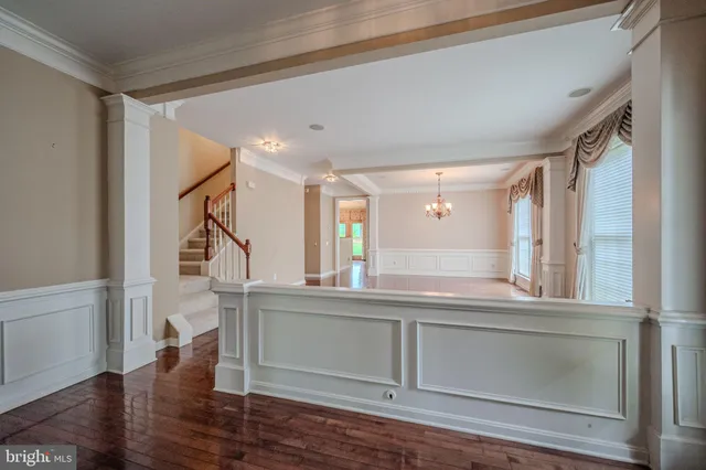 a view of entryway and hall with wooden floor