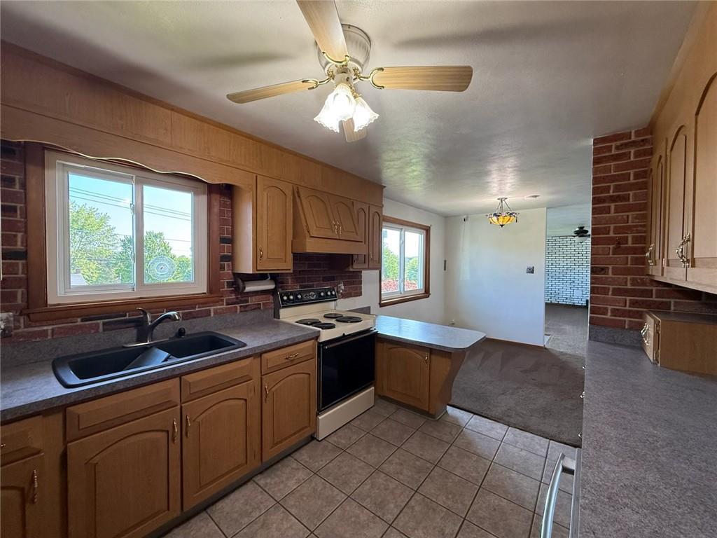 105 Ridgeview Drive Salix, PA 15952 - Photo 7 of 25 a kitchen with a sink stove and cabinets