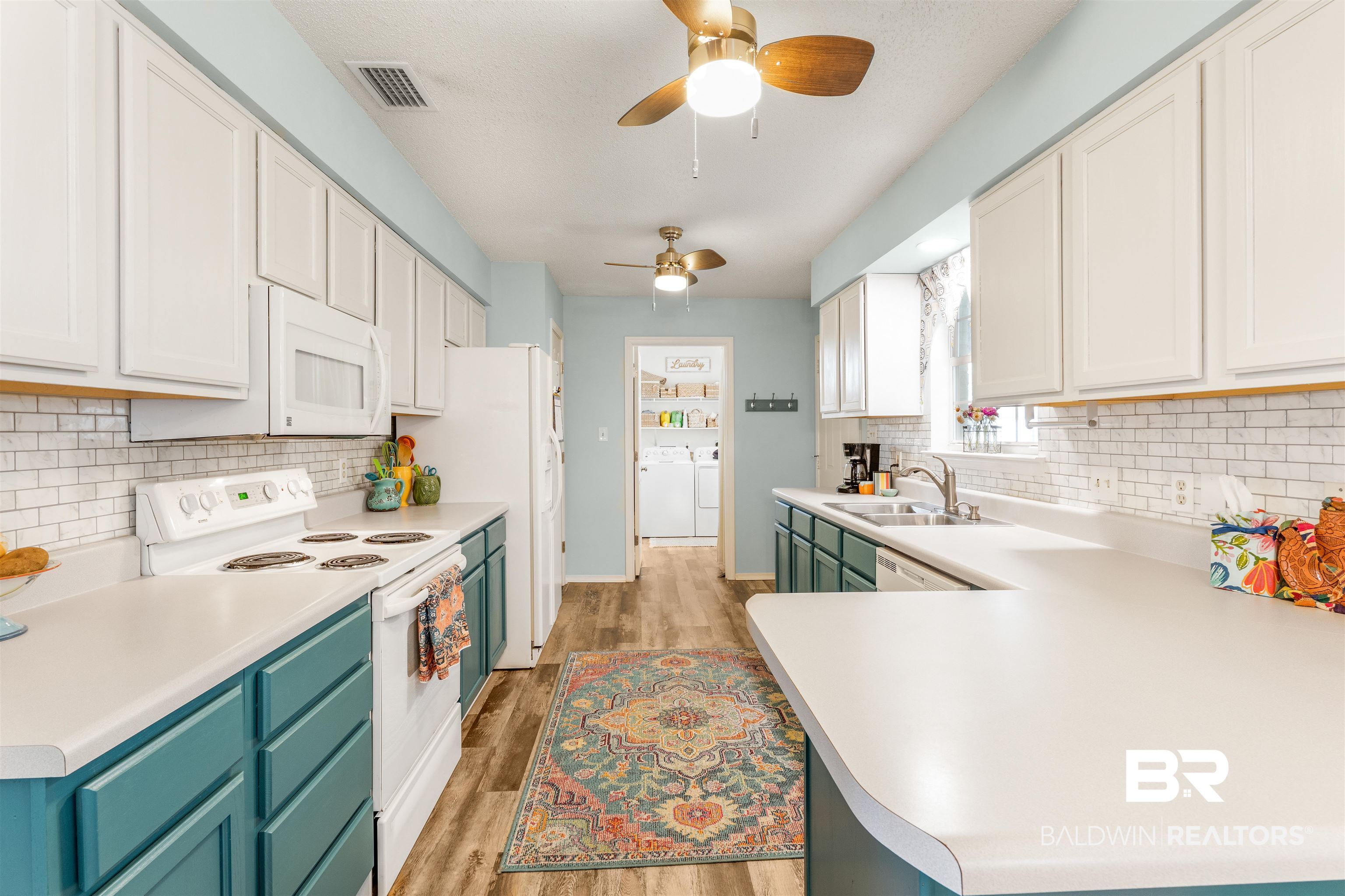 518 Ariel Avenue Foley, AL 36535 - Photo 11 of 47 Kitchen featuring white cabinets, light wood-type flooring, white appliances, washing machine and clothes dryer, and ceiling fan