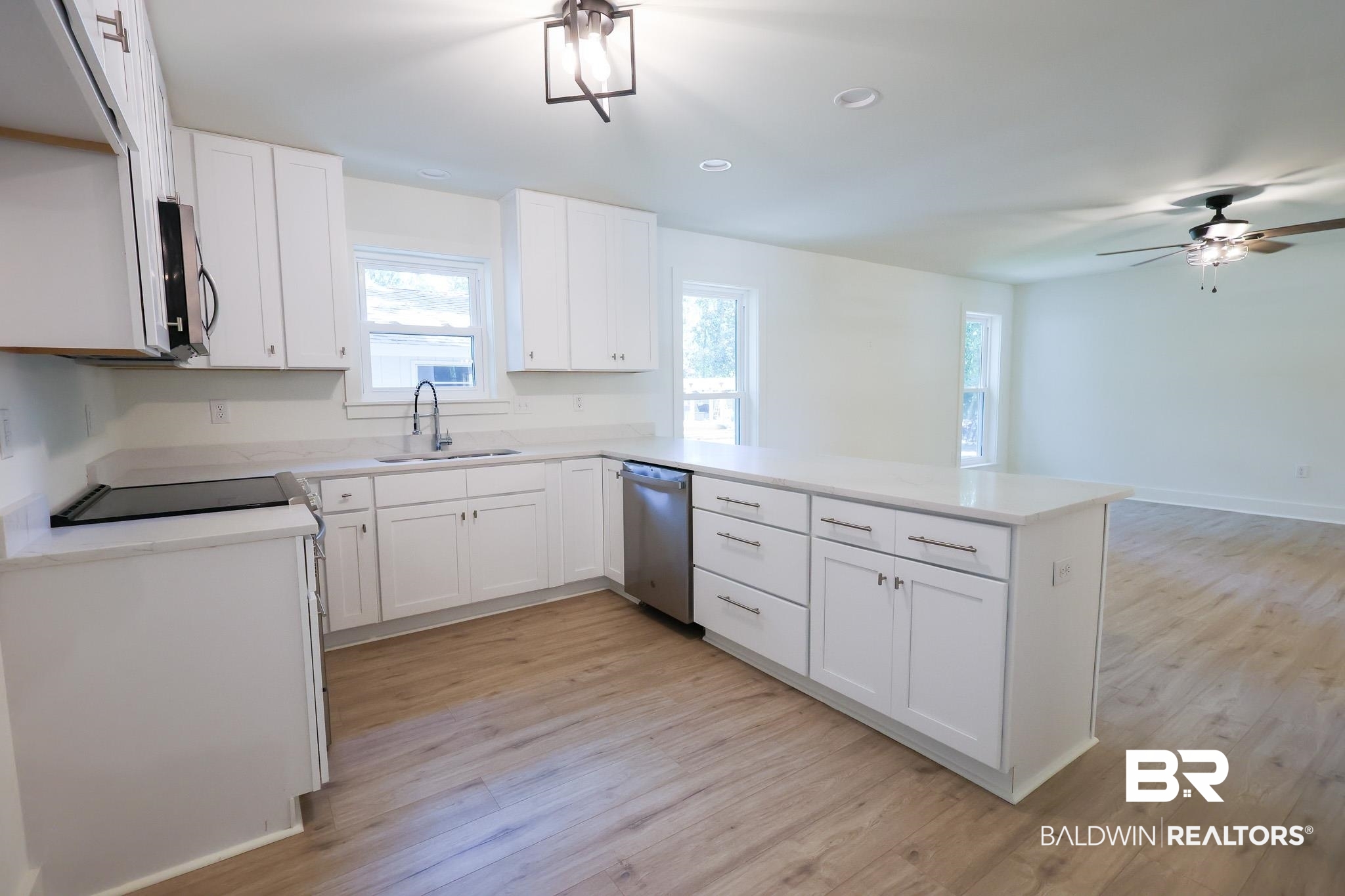 12190 Pecan Grove Street Magnolia Springs, AL 36555 - Photo 6 of 45 Kitchen featuring light hardwood / wood-style flooring, kitchen peninsula, ceiling fan, stainless steel appliances, and sink