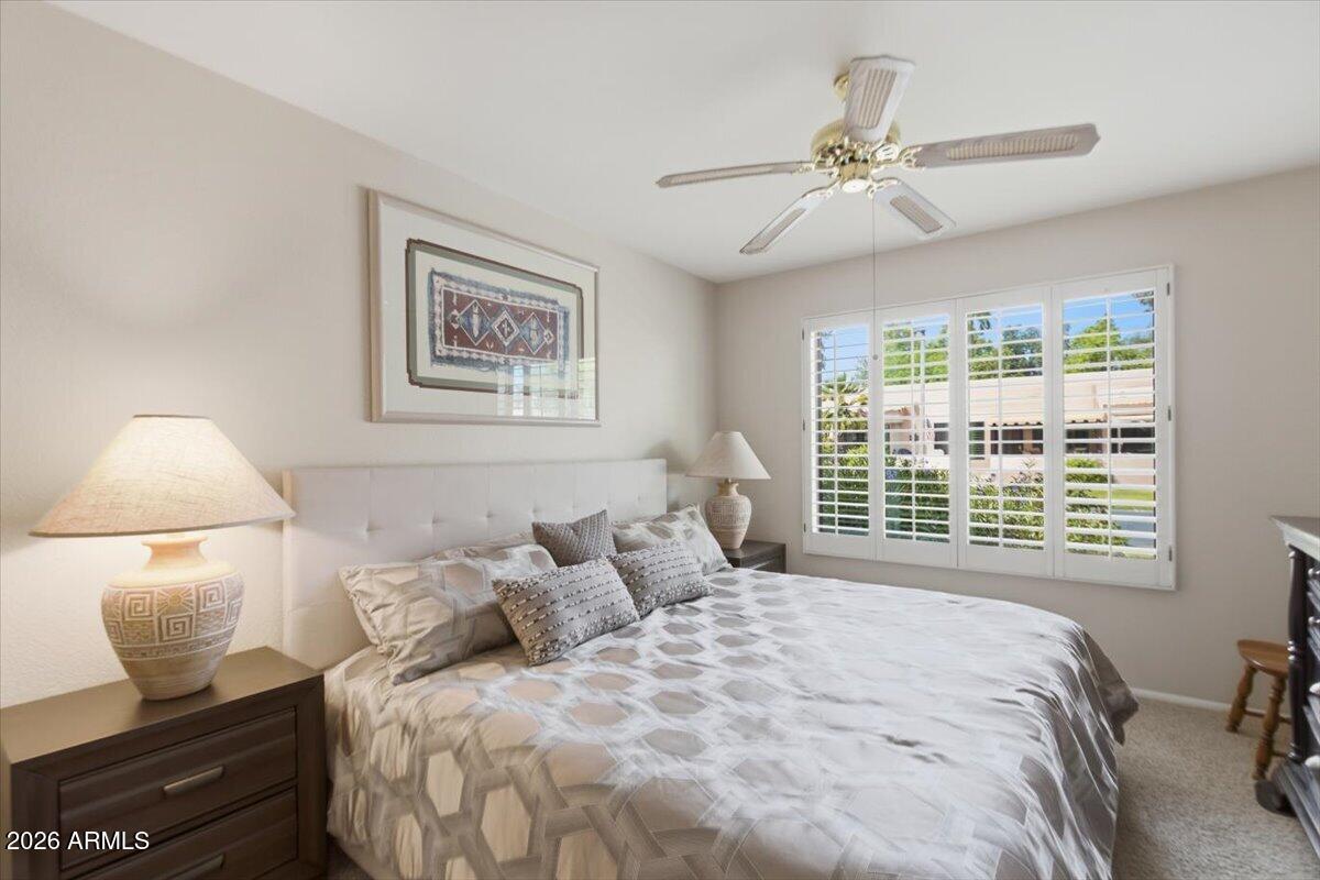 14300 West Bell Road, Unit 211 Surprise, AZ 85374 - Photo 16 of 42 a bedroom with a bed and window