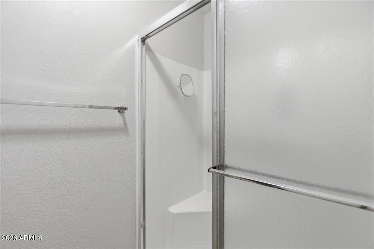 14300 West Bell Road, Unit 211 Surprise, AZ 85374 - Photo 20 of 42 a bathroom with a glass shower door