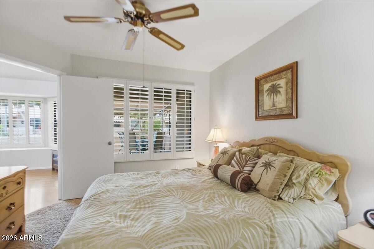14300 West Bell Road, Unit 211 Surprise, AZ 85374 - Photo 24 of 42 a bedroom with a large bed and a window