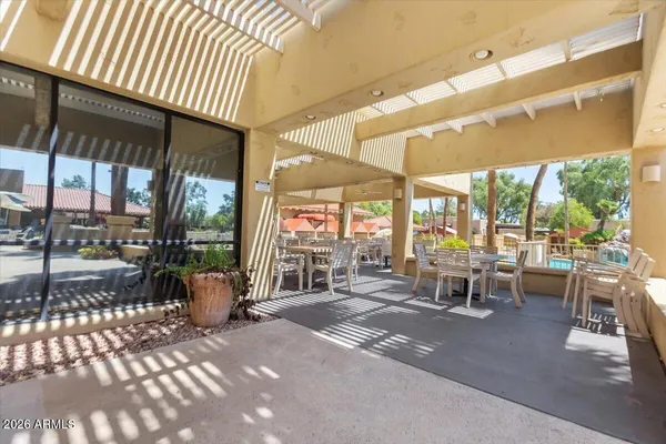a view of a balcony with a floor to ceiling window and wooden fence