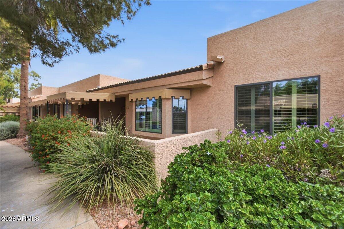 14300 West Bell Road, Unit 211 Surprise, AZ 85374 - Photo 3 of 42 front view of a house with a garden