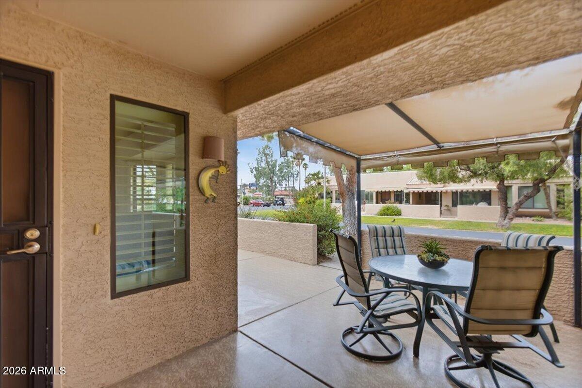 14300 West Bell Road, Unit 211 Surprise, AZ 85374 - Photo 5 of 42 a patio with table and chairs