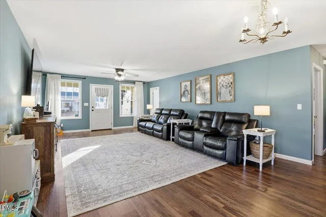a living room with furniture and wooden floor