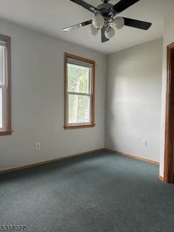 a view of a livingroom with furniture and lamp