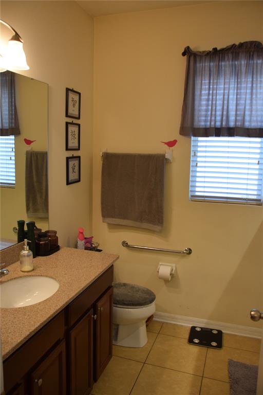 3500 Sprite Lane St. Cloud, FL 34772 - Photo 14 of 52 a bathroom with a sink a toilet and mirror