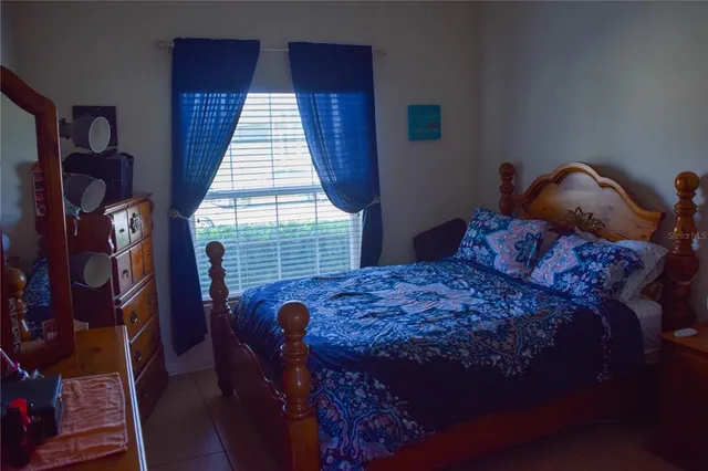 a bed sitting in a bedroom next to a window