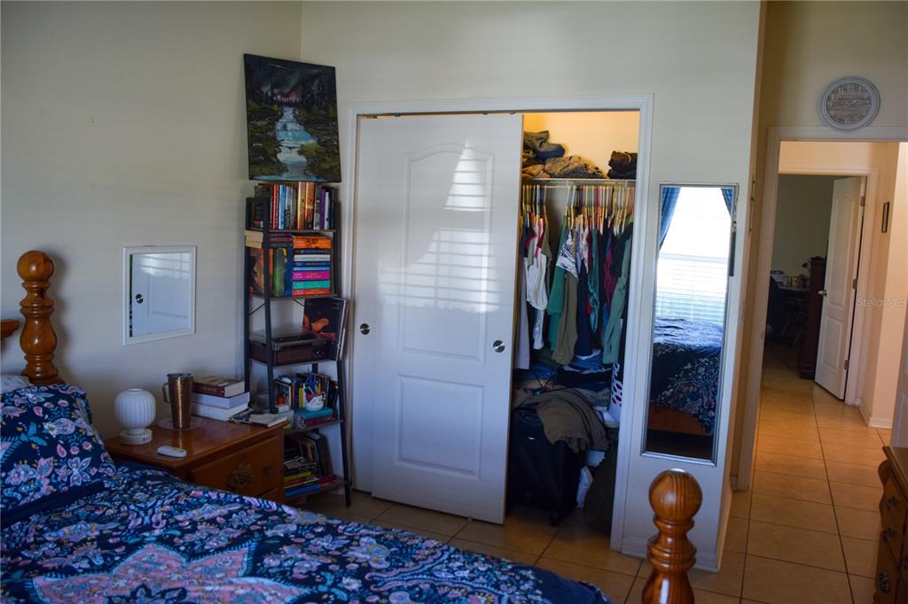 3500 Sprite Lane St. Cloud, FL 34772 - Photo 18 of 52 a view of walk in closet with clothes and shoes