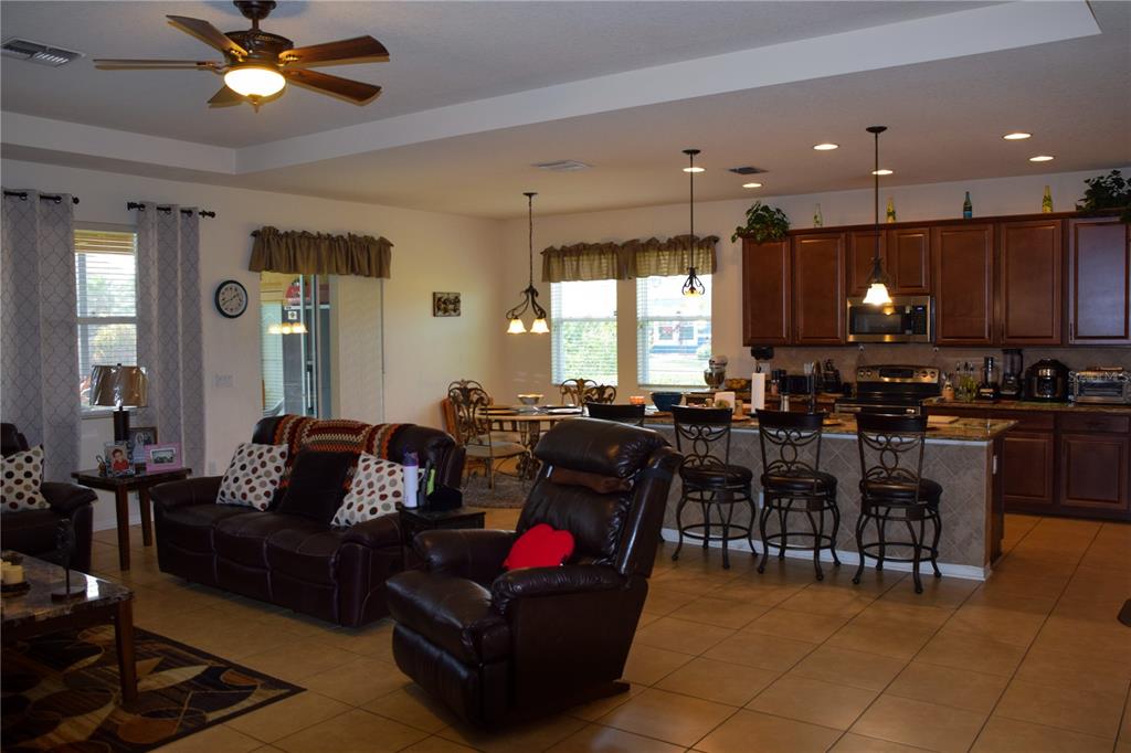 3500 Sprite Lane St. Cloud, FL 34772 - Photo 28 of 52 a living room with lots of furniture and kitchen view
