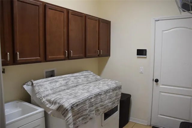 a living room with furniture a window and a chandelier