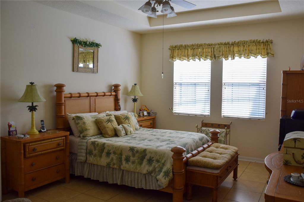 3500 Sprite Lane St. Cloud, FL 34772 - Photo 35 of 52 a bedroom with a bed and a chandelier