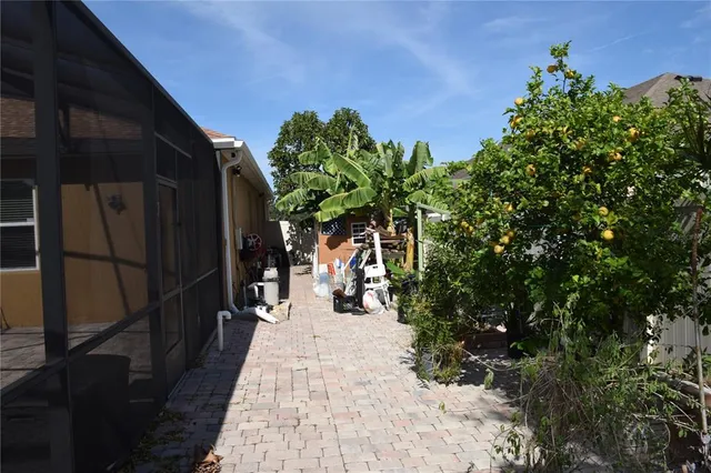 a view of a patio with table and chairs under an umbrella