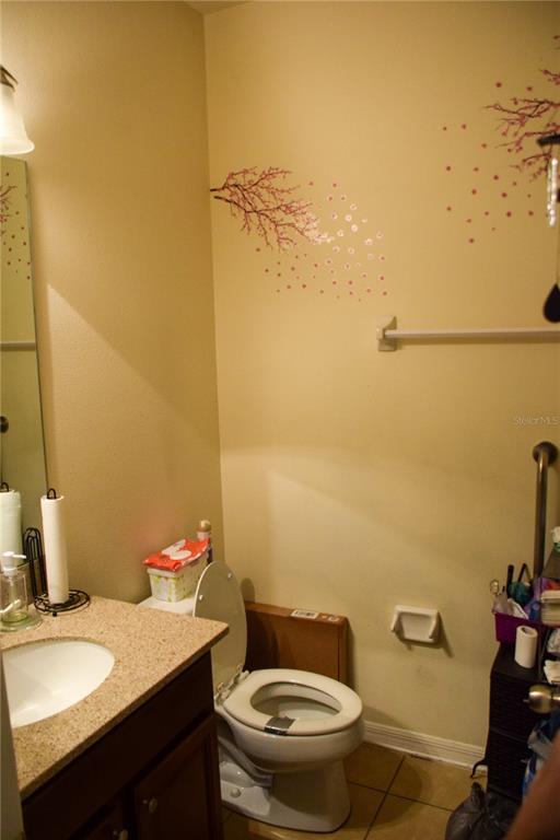 3500 Sprite Lane St. Cloud, FL 34772 - Photo 7 of 52 a bathroom with a granite countertop sink mirror and toilet
