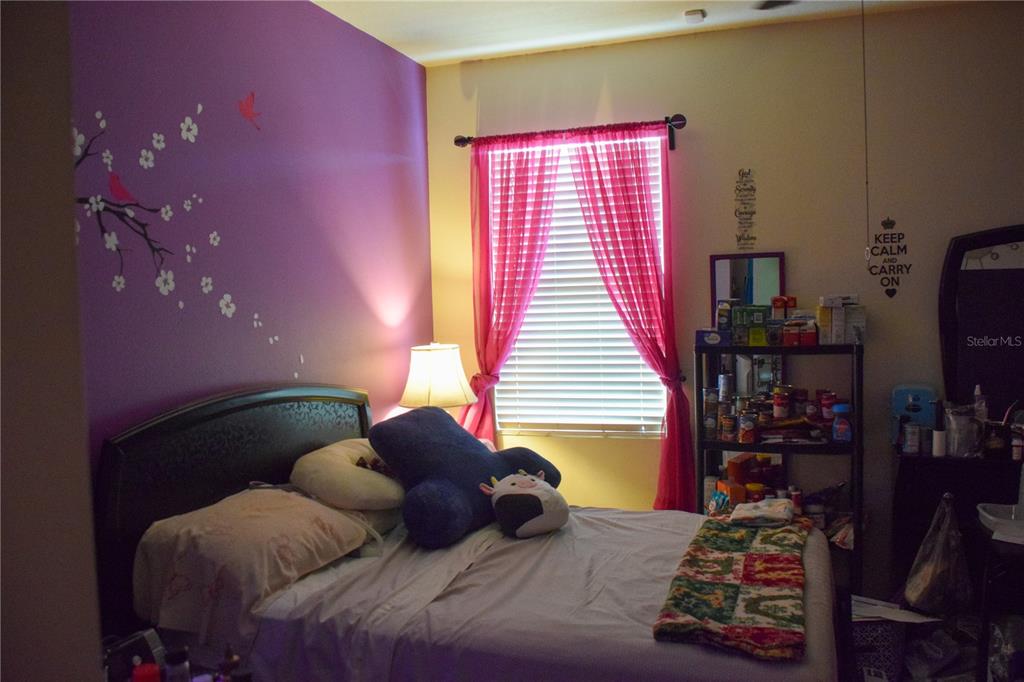 3500 Sprite Lane St. Cloud, FL 34772 - Photo 8 of 52 a large bed sitting in a bedroom next to a window