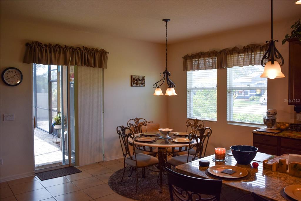 3500 Sprite Lane St. Cloud, FL 34772 - Photo 9 of 52 a view of a dining room and livingroom with furniture wooden floor and a chandelier