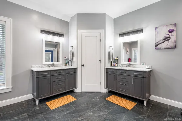 a bathroom with a sink vanity and a mirror