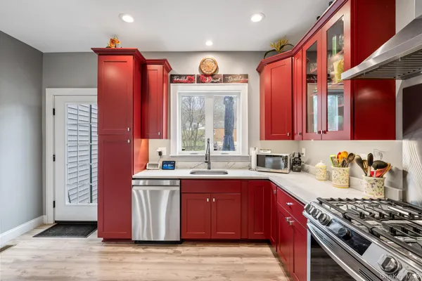 a kitchen with stainless steel appliances granite countertop a stove a sink and a microwave