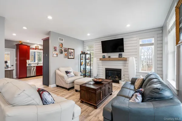 a living room with furniture fireplace and flat screen tv