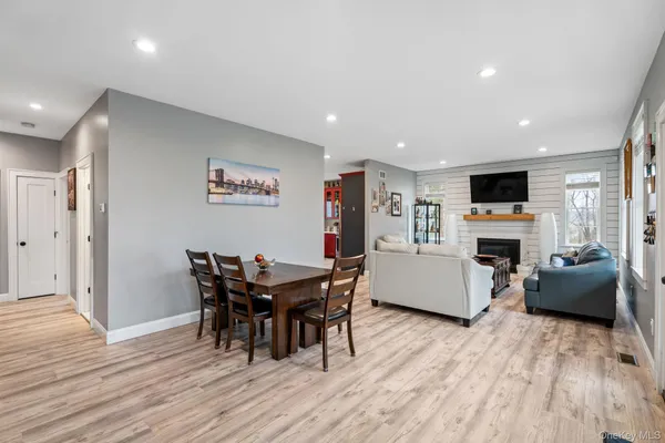 a view of a dining room with furniture and fireplace
