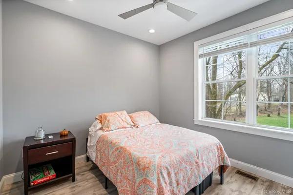a bedroom with a bed dresser and a window