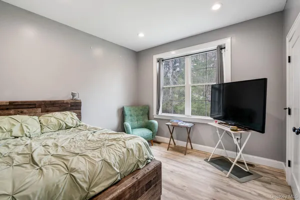 a bedroom with a bed and a flat screen tv