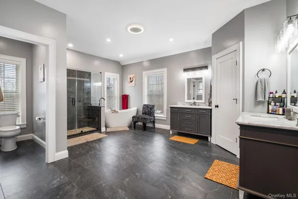 a spacious bathroom with a sink mirror and toilet