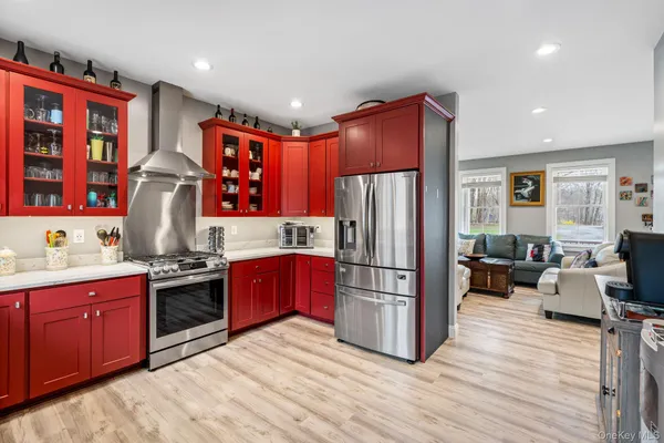 a kitchen with stainless steel appliances granite countertop a refrigerator stove and sink