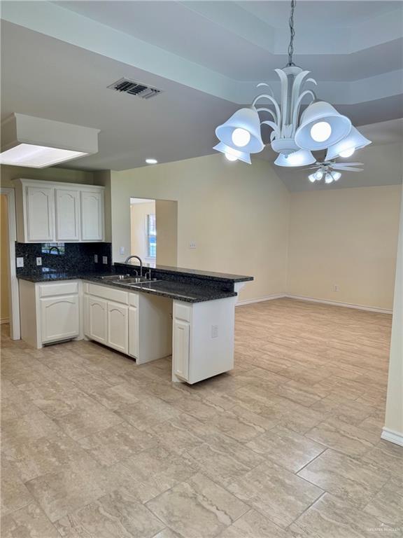 2207 Turtle Court Mission, TX 78572 - Photo 9 of 22 a kitchen with granite countertop a white cabinets and chandelier