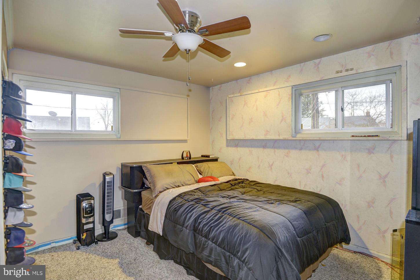 7415 Sudbrook Road Baltimore, MD 21208 - Photo 11 of 13 a bed sitting in a bedroom next to a window