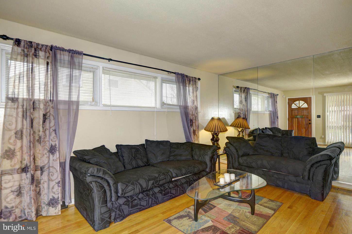7415 Sudbrook Road Baltimore, MD 21208 - Photo 3 of 13 a living room with furniture and a large window