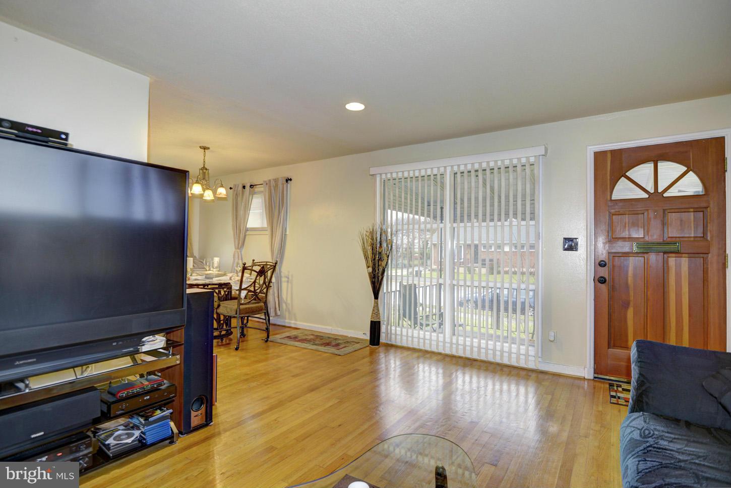 7415 Sudbrook Road Baltimore, MD 21208 - Photo 4 of 13 a view of an empty room with wooden floor and a window